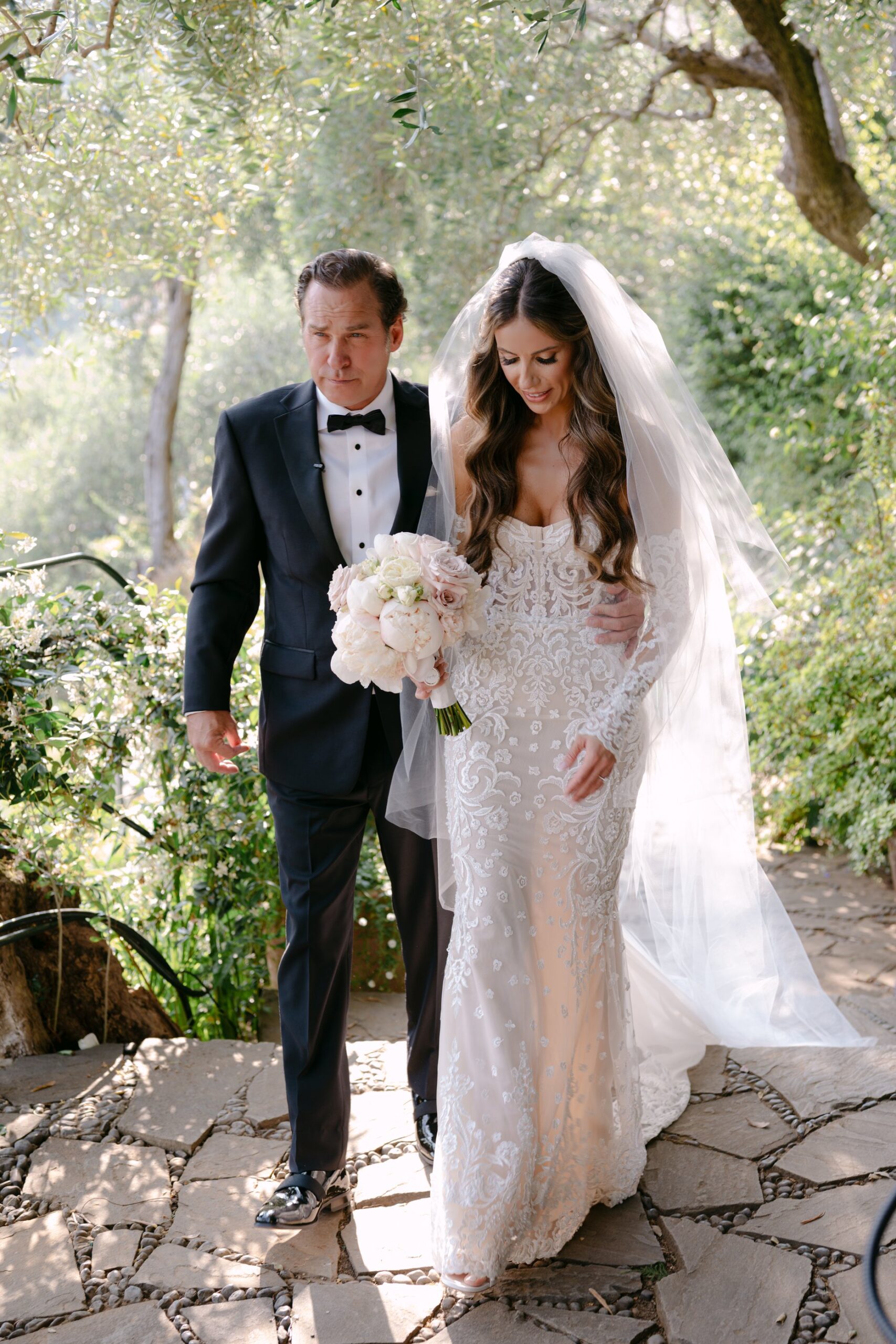 Bride and groom walking through the gardens of Belmond Hotel Splendido during their portofino elopement