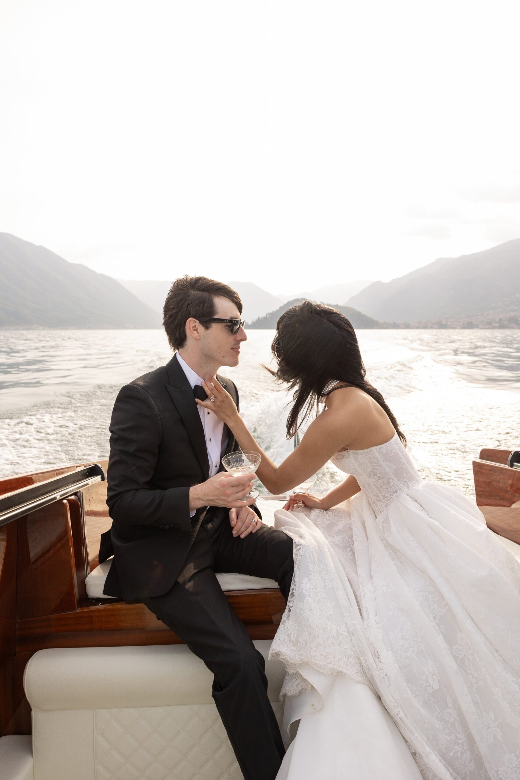 Newlyweds on a private boat on Lake Como after their villa balbianello micro wedding